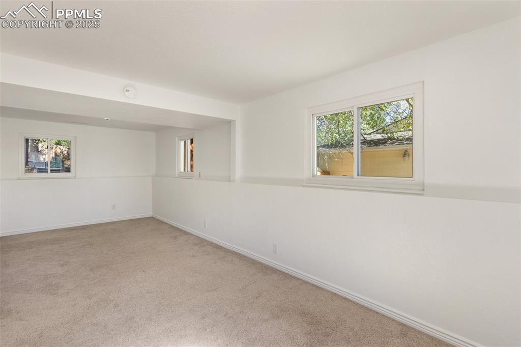 Image 27 of 47: Carpeted empty room featuring baseboards