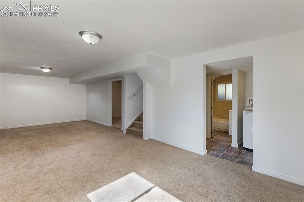 Image 30 of 47: Below grade area featuring carpet flooring and stairs