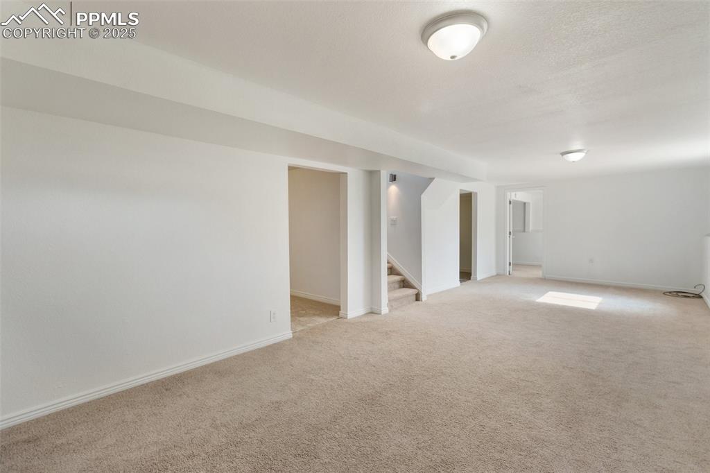 Image 31 of 47: Finished below grade area with carpet floors and stairway