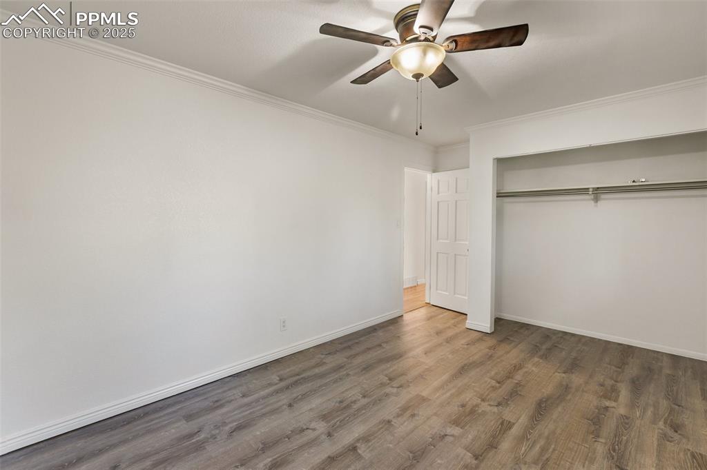 Image 37 of 47: Unfurnished bedroom featuring wood finished floors, crown molding, a ceilin
