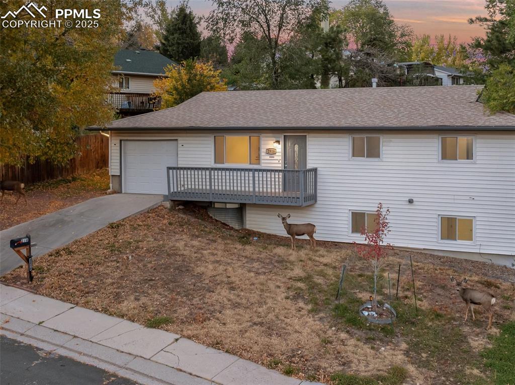 Image 4 of 47: Single story home with driveway, roof with shingles, a garage, and a deck