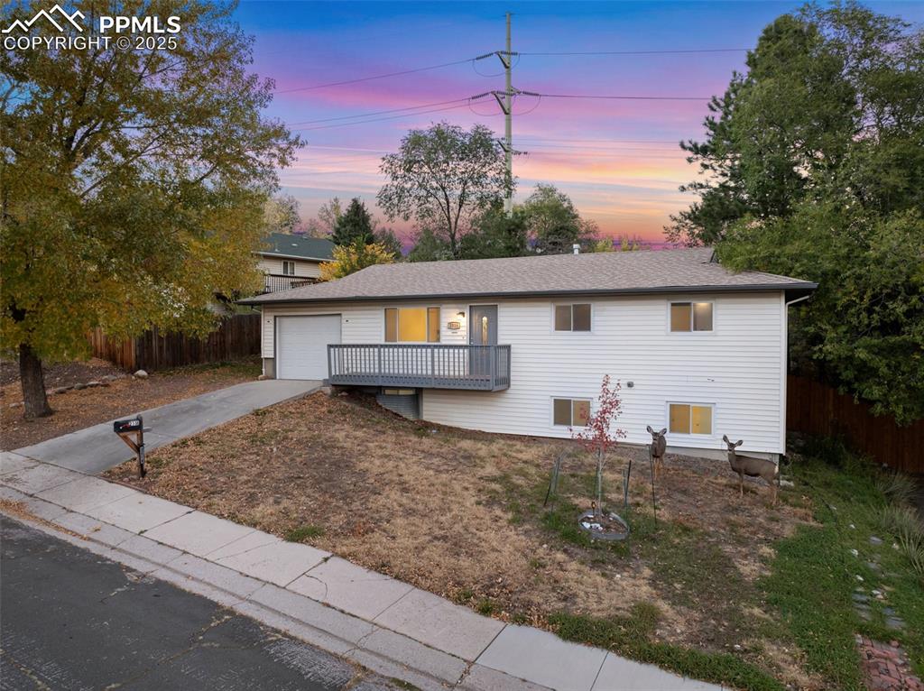 Image 46 of 47: Ranch-style house featuring driveway, an attached garage, and roof with shi