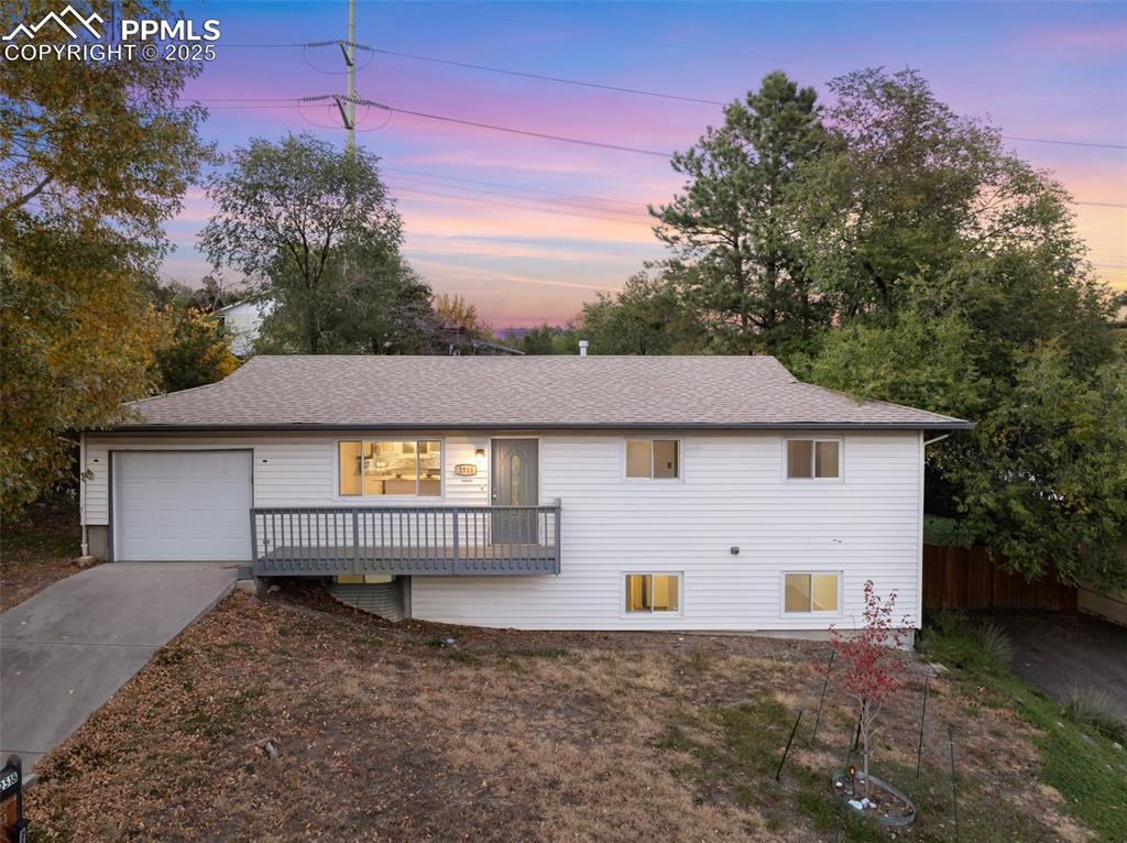 Image 6 of 47: Single story home with concrete driveway, an attached garage, roof with shi