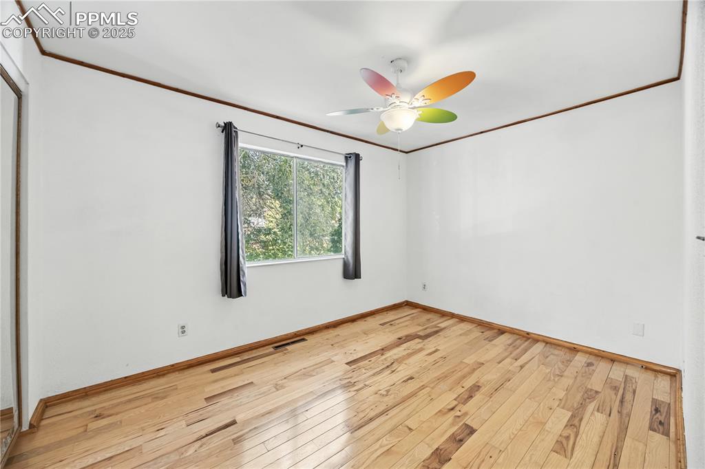 Image 13 of 23: Unfurnished room with ornamental molding, light wood-style floors, and ceil