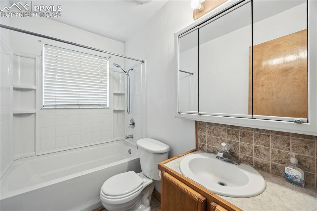 Image 15 of 23: Full bath featuring shower / washtub combination, vanity, and decorative ba