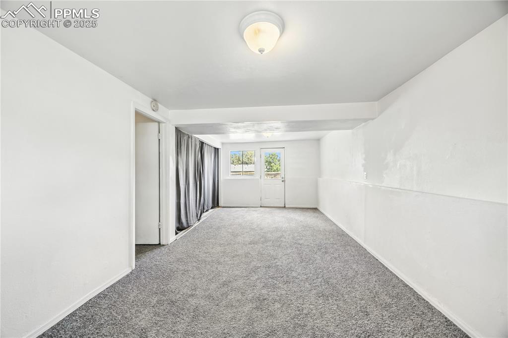Image 16 of 23: Carpeted spare room with baseboards