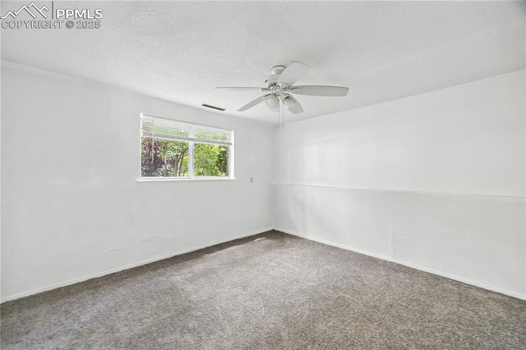Image 18 of 23: Unfurnished room featuring carpet flooring, a textured ceiling, and a ceili
