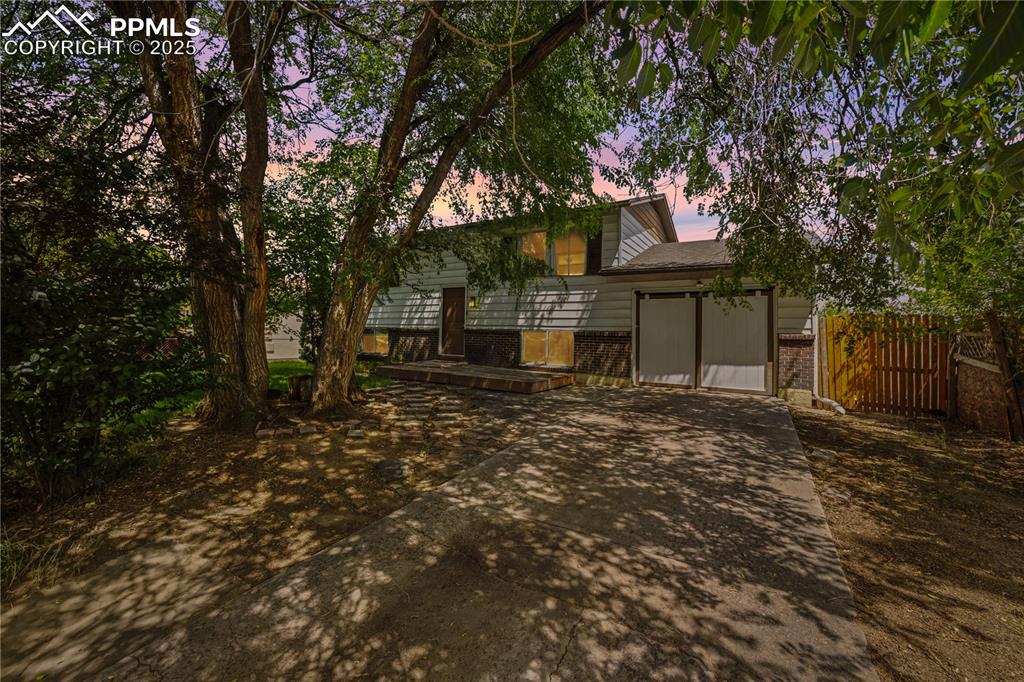 Image 2 of 23: Back of property featuring brick siding