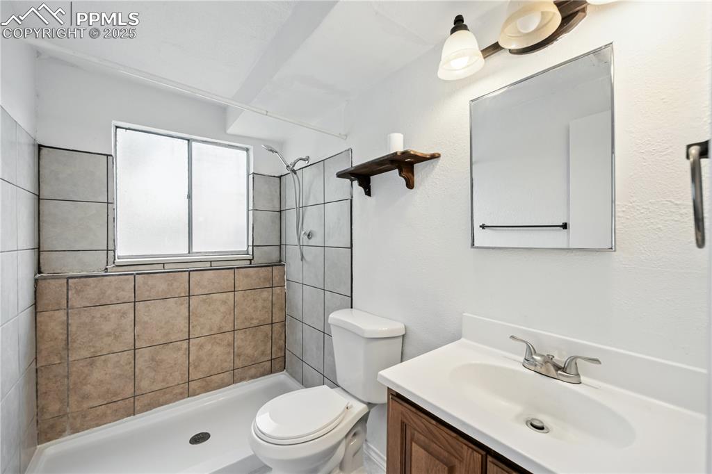 Image 20 of 23: Bathroom with vanity and a shower stall