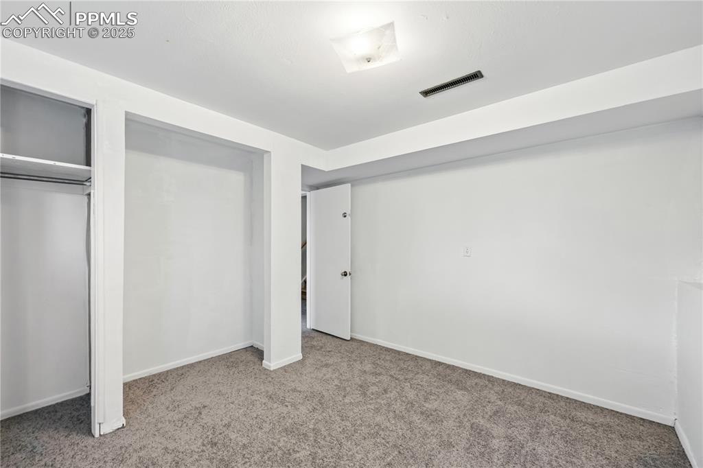 Image 22 of 23: Unfurnished bedroom featuring carpet and a closet