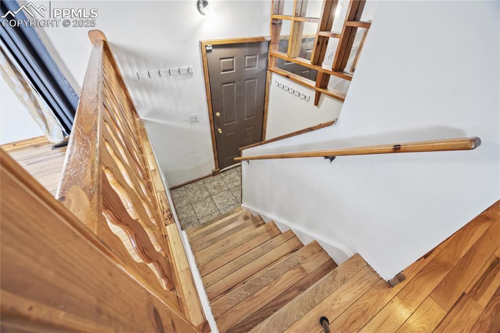 Image 4 of 23: Stairs with hardwood / wood-style floors