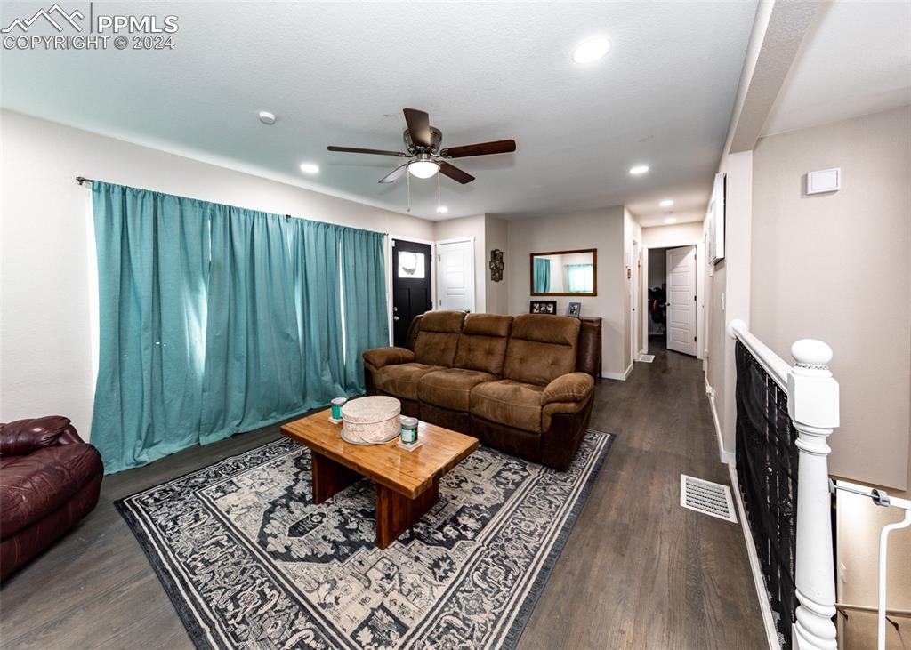 Image 3 of 30: Living room featuring dark hardwood / wood-style flooring and ceiling fan