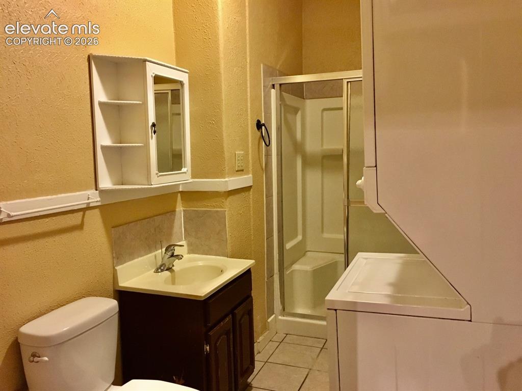 Image 8 of 27: Bathroom featuring a vanity with a base cabinet, a built-in shower stall wi