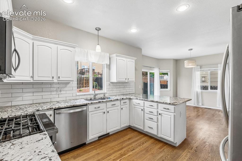Image 11 of 46: Open-concept kitchen with convenient breakfast bar and spacious breakfast a