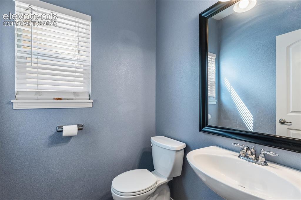 Image 15 of 46: Main floor powder room with pedestal sink