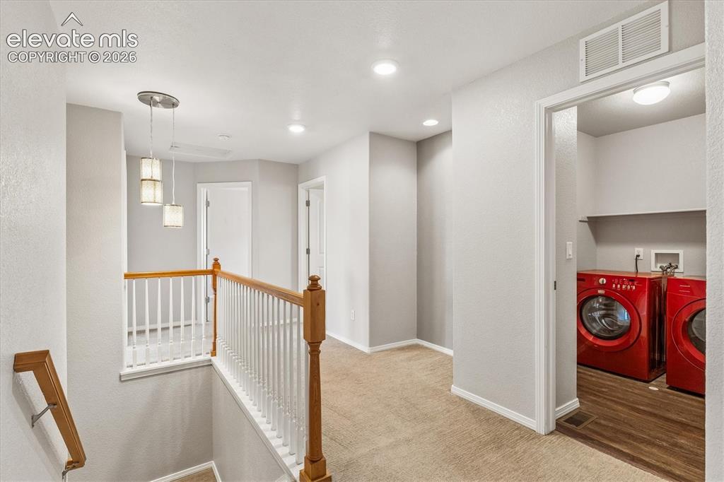 Image 16 of 46: Stairs to upper floor and laundry