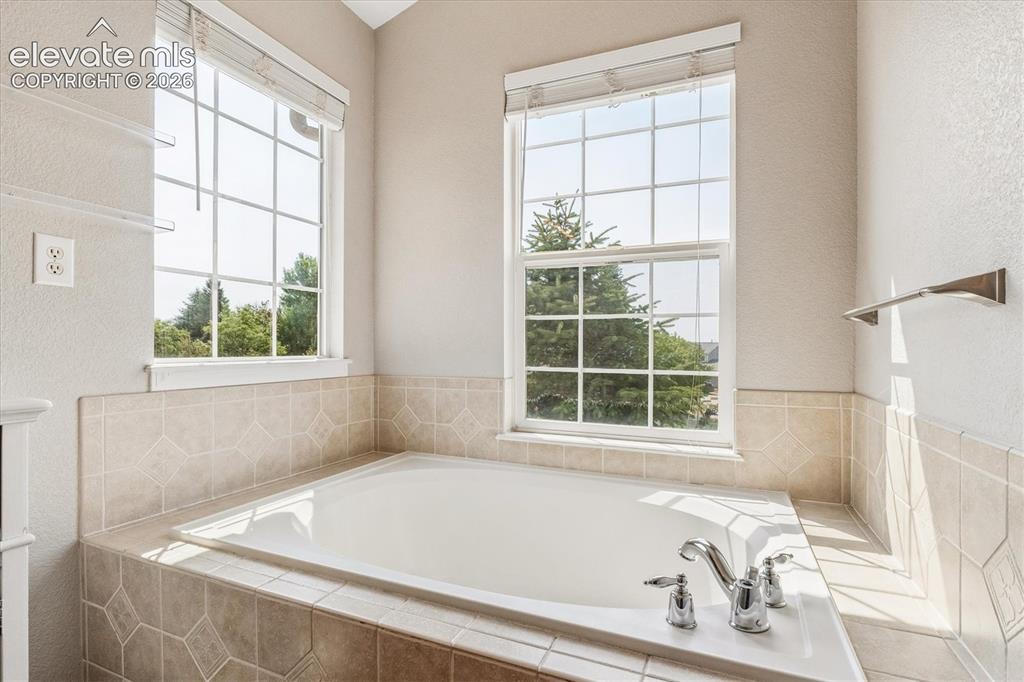 Image 20 of 46: Primary bathroom features a spacious garden tub