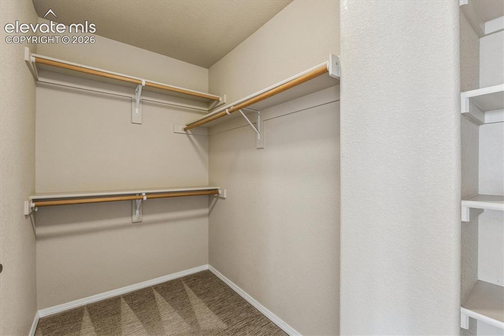 Image 23 of 46: Primary bedroom features TWO separate walk-in closets