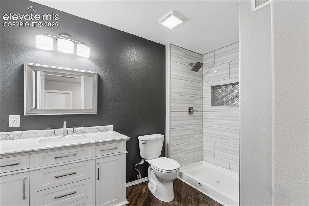 Image 38 of 46: Basement 3/4 bathroom features single vanity with marble countertop and mod
