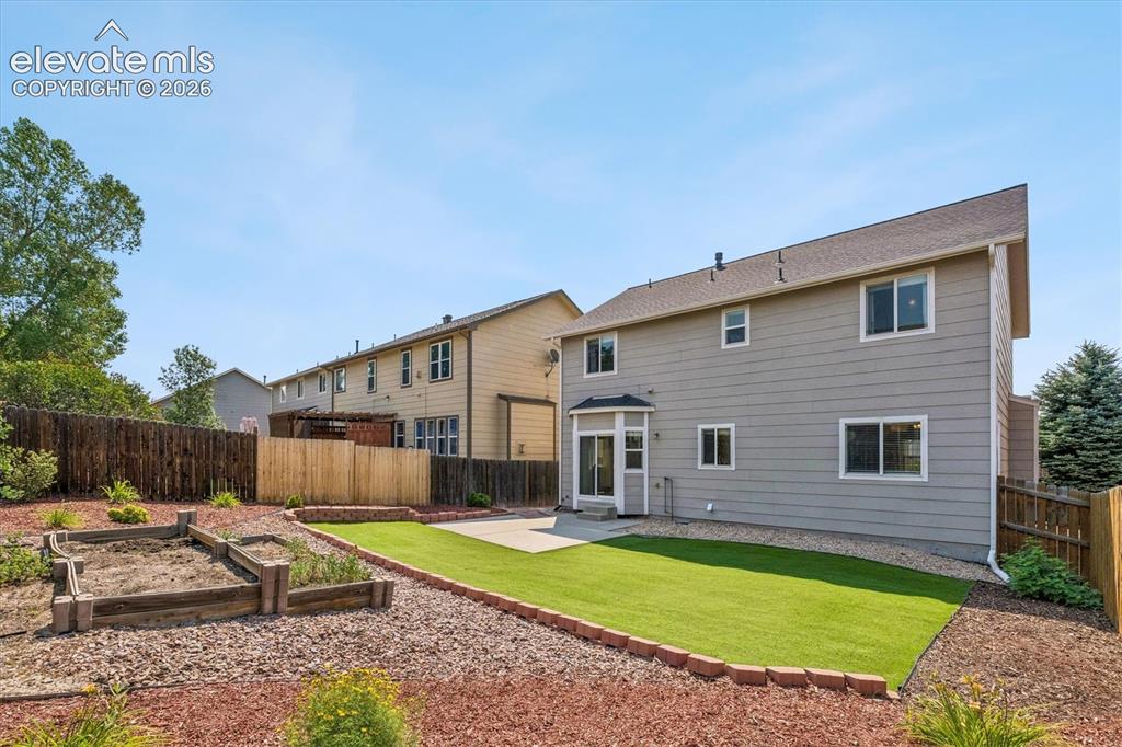 Image 41 of 46: Spacious back yard with turf and low maintenance landscaping