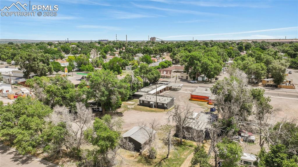 Image 29 of 32: Aerial perspective of suburban area with a tree filled landscape