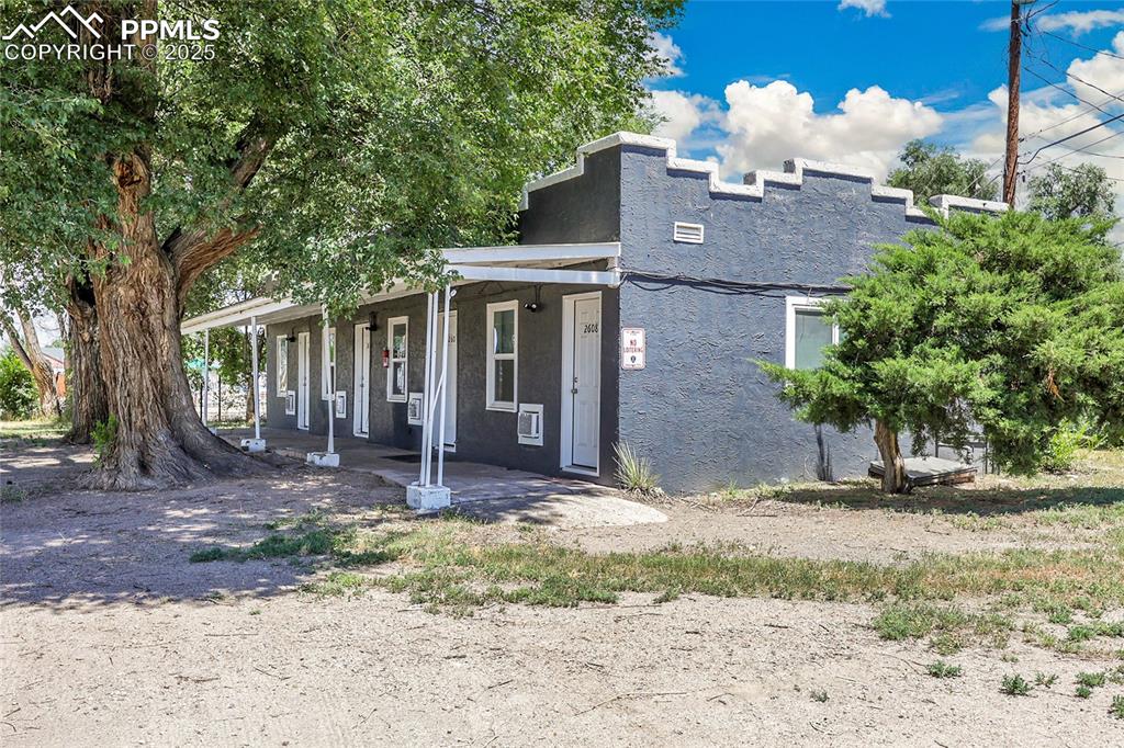 Image 5 of 32: View of front of property with stucco siding and a porch