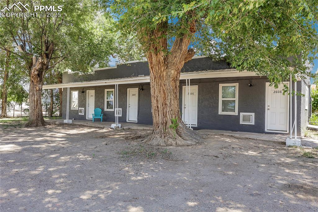 Image 6 of 32: View of front of property with stucco siding and covered porch