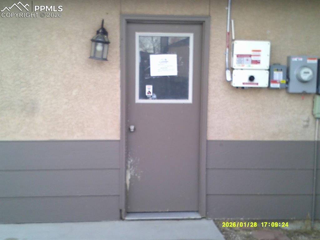 Image 21 of 22: Doorway to property with stucco siding