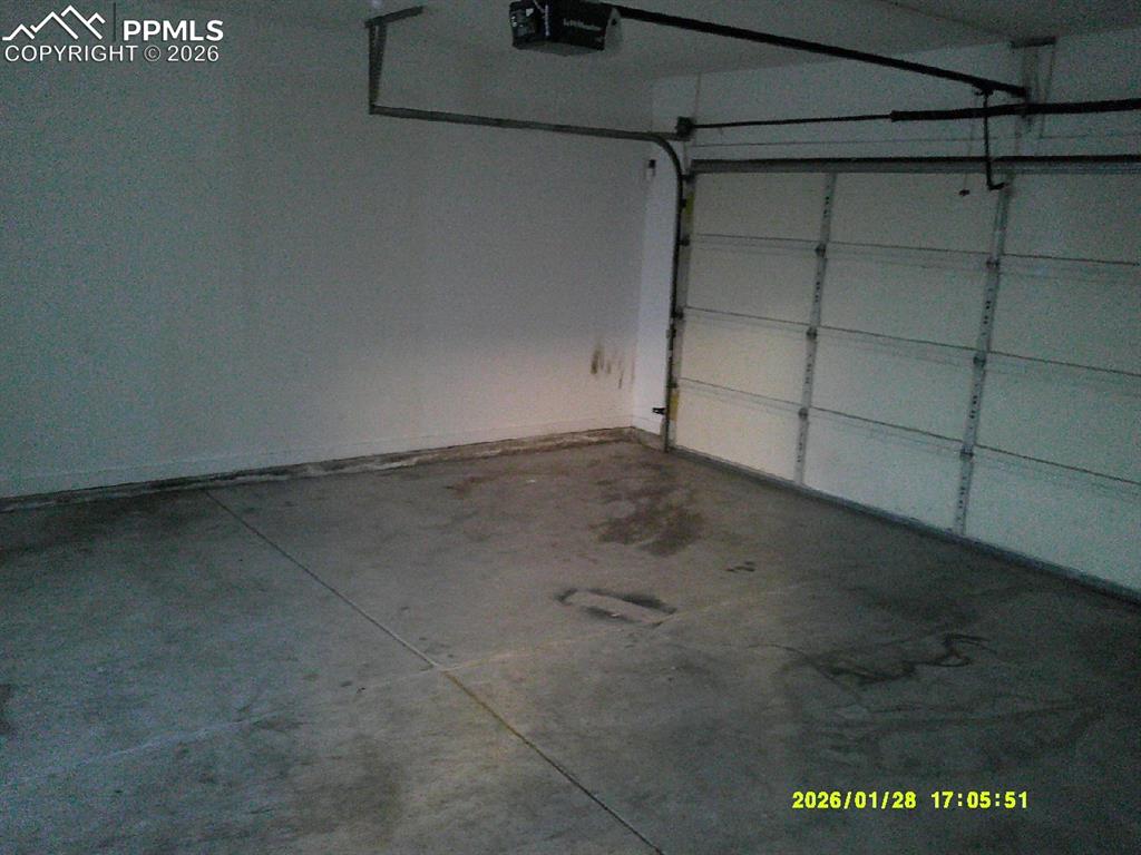 Image 5 of 22: Garage with a garage door opener