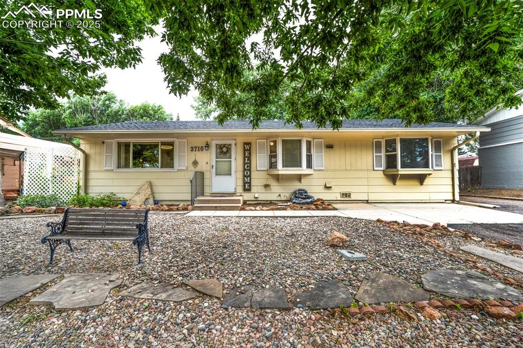 Caption: Ranch-style house featuring park like setting