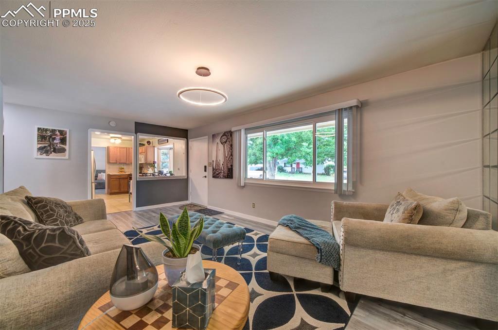 Image 4 of 32: Living area featuring light wood-style flooring and baseboards