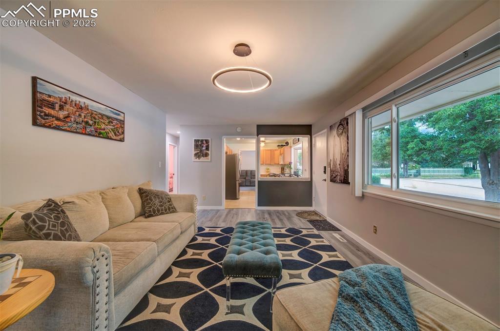 Image 5 of 32: Living room with light wood-style flooring and baseboards