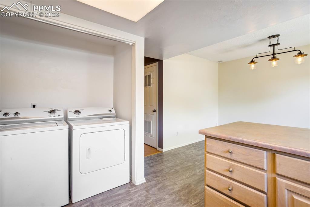 Image 10 of 49: Dedicated laundry alcove with overhead lighting
