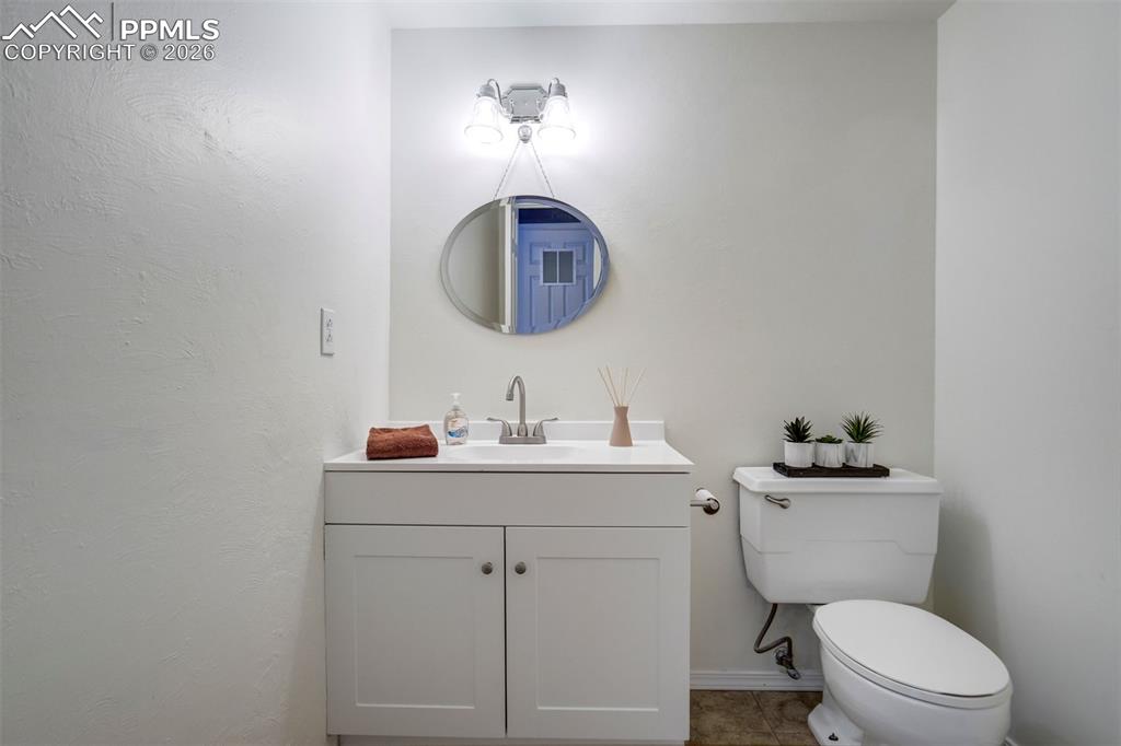 Image 13 of 49: White vanity with dual cabinet doors and brushed nickel hardware, paired wi