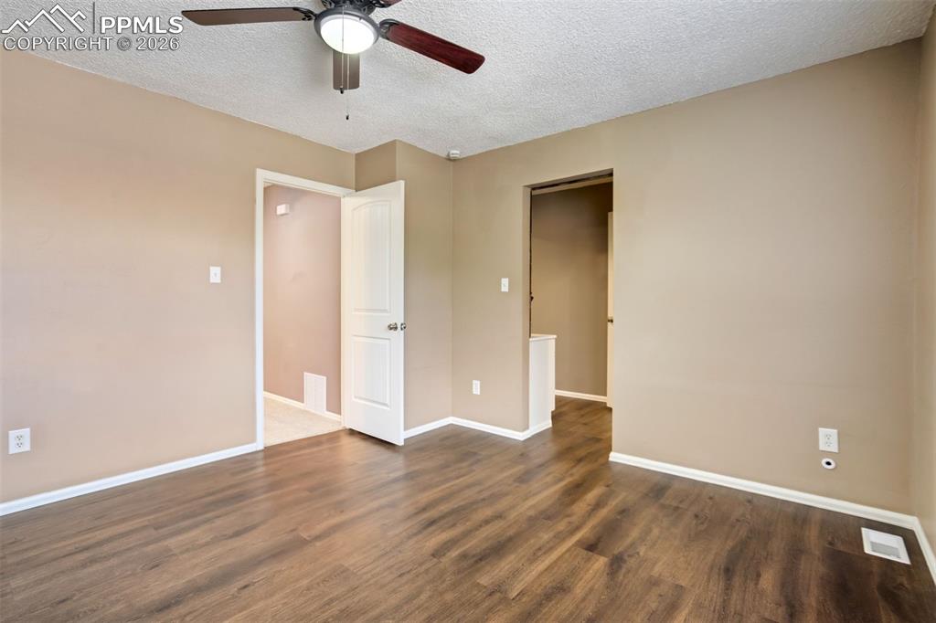 Image 17 of 49: Spacious room featuring wood-finish flooring, neutral-toned walls, a ceilin