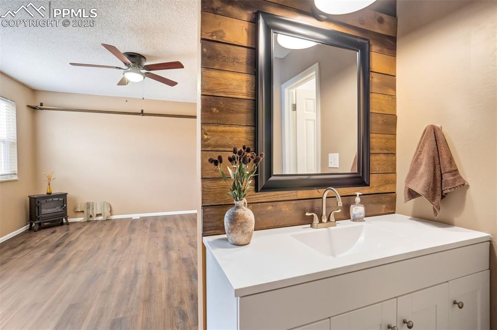 Image 19 of 49: Bathroom vanity featuring a vessel sink with brushed nickel faucet, framed 