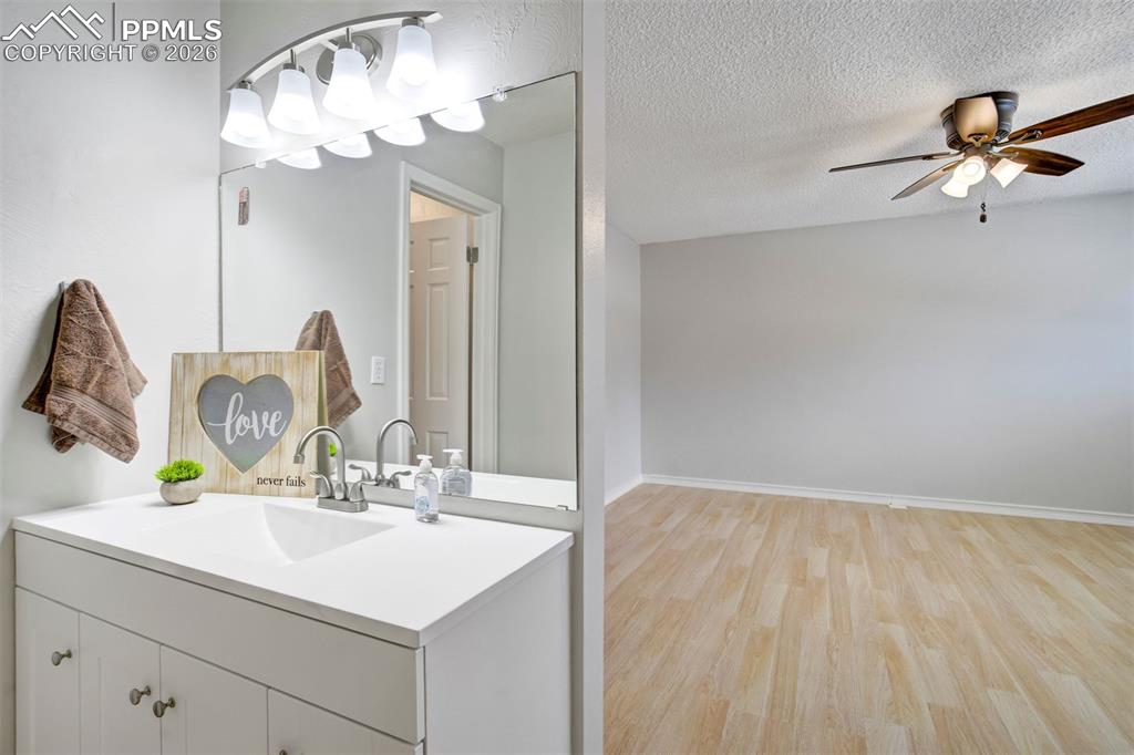 Image 23 of 49: Bathroom vanity with integrated sink, white countertop, and brushed nickel 