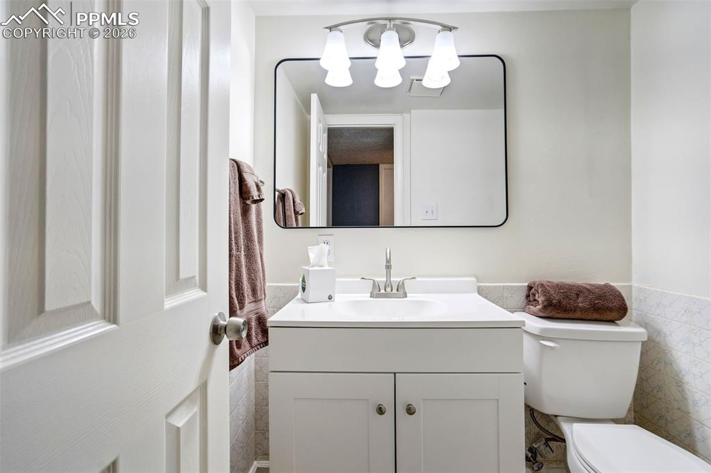 Image 32 of 49: Modern vanity with white cabinet storage, integrated sink, and brushed nick