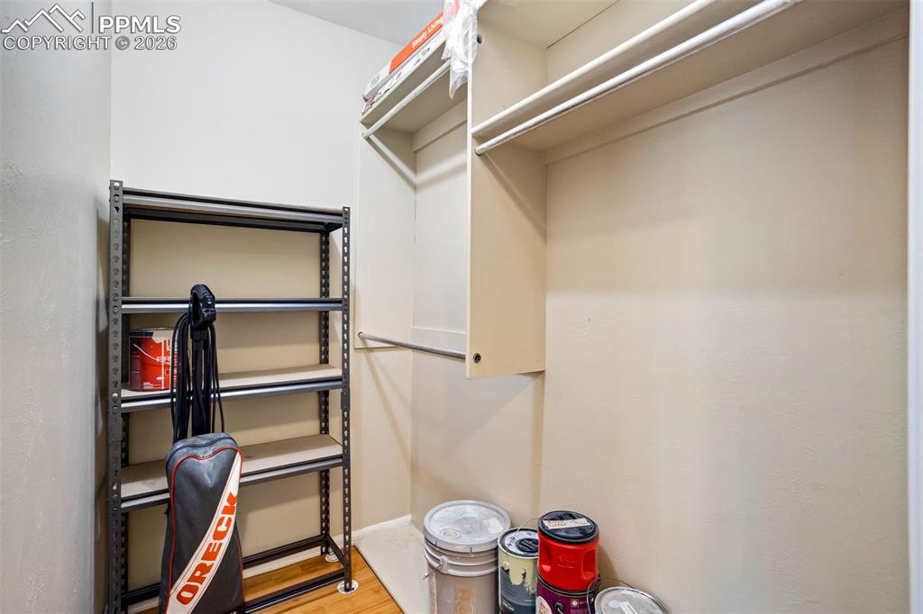 Image 36 of 49: Built-in shelving and hanging rods offer versatile storage solutions