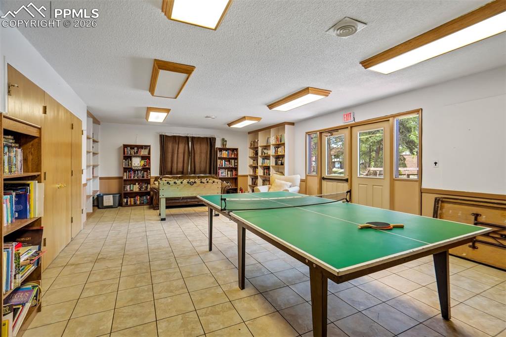 Image 46 of 49: Recreational room featuring a ping-pong table and foosball table