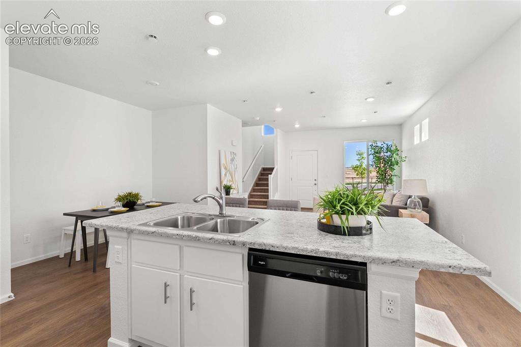 Image 12 of 30: Kitchen island with dual stainless steel sink, integrated dishwasher, and l