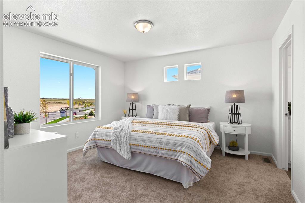 Image 20 of 30: Bright interior featuring a large window, neutral wall paint, and plush car