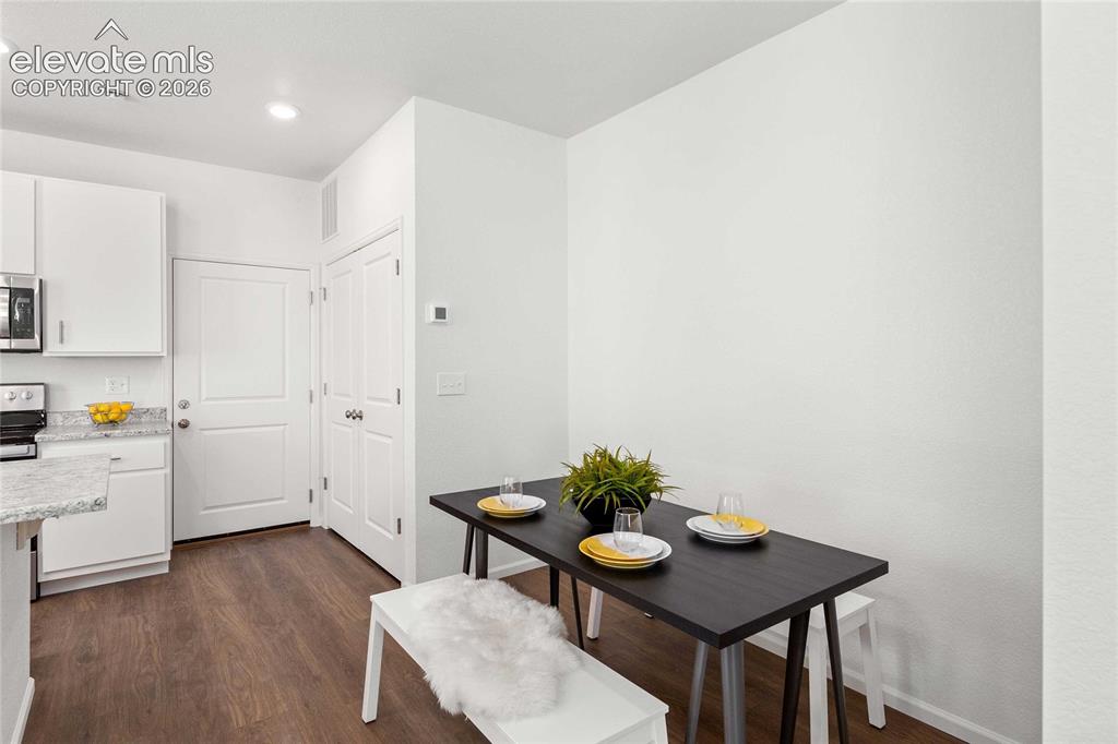 Image 3 of 30: Wood-finish flooring, white cabinetry, integrated stainless steel appliance