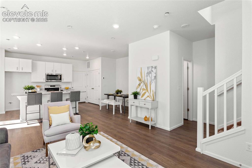 Image 7 of 30: Contemporary kitchen featuring white cabinetry, stainless steel appliances,