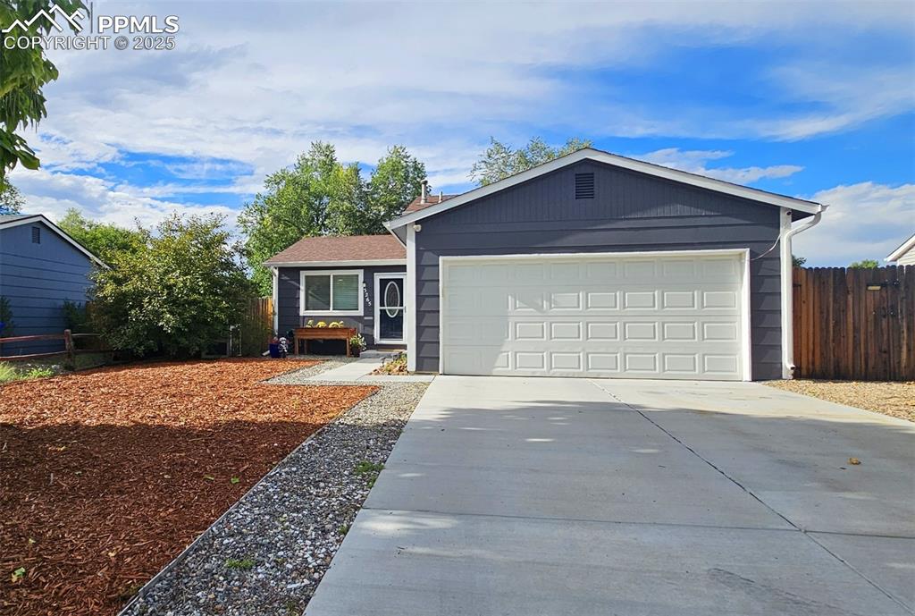 Caption: Ranch-style house with driveway and a garage
