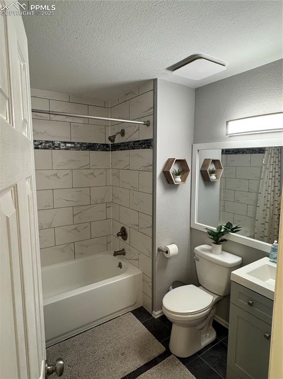 Image 15 of 40: Full bath featuring shower / bathtub combination with curtain, vanity, dark