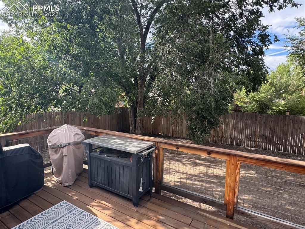 Image 23 of 40: Deck featuring a grill and a fenced backyard