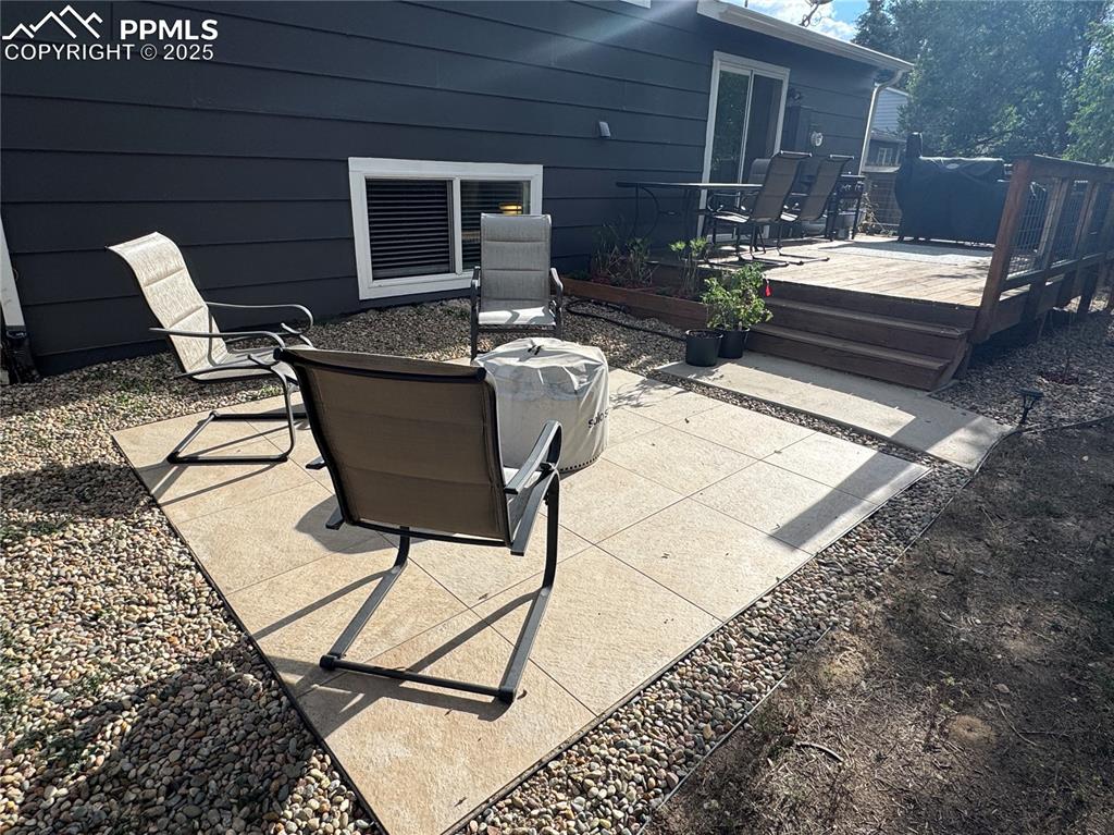 Image 25 of 40: View of patio / terrace with outdoor dining area and a deck
