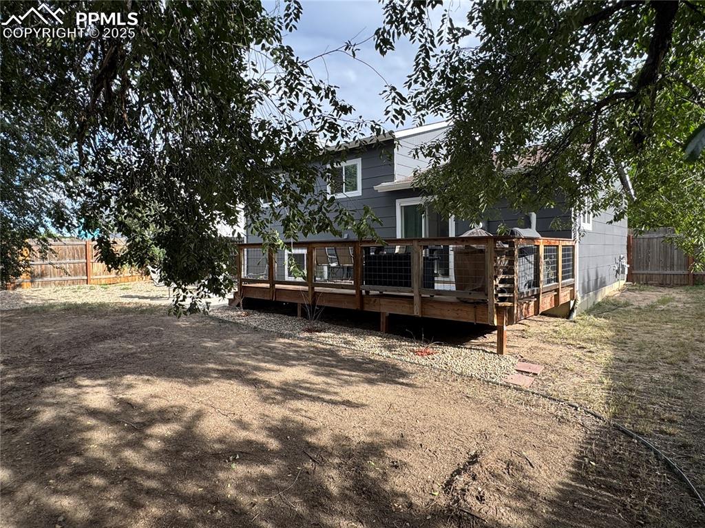 Image 28 of 40: Back of property with a wooden deck