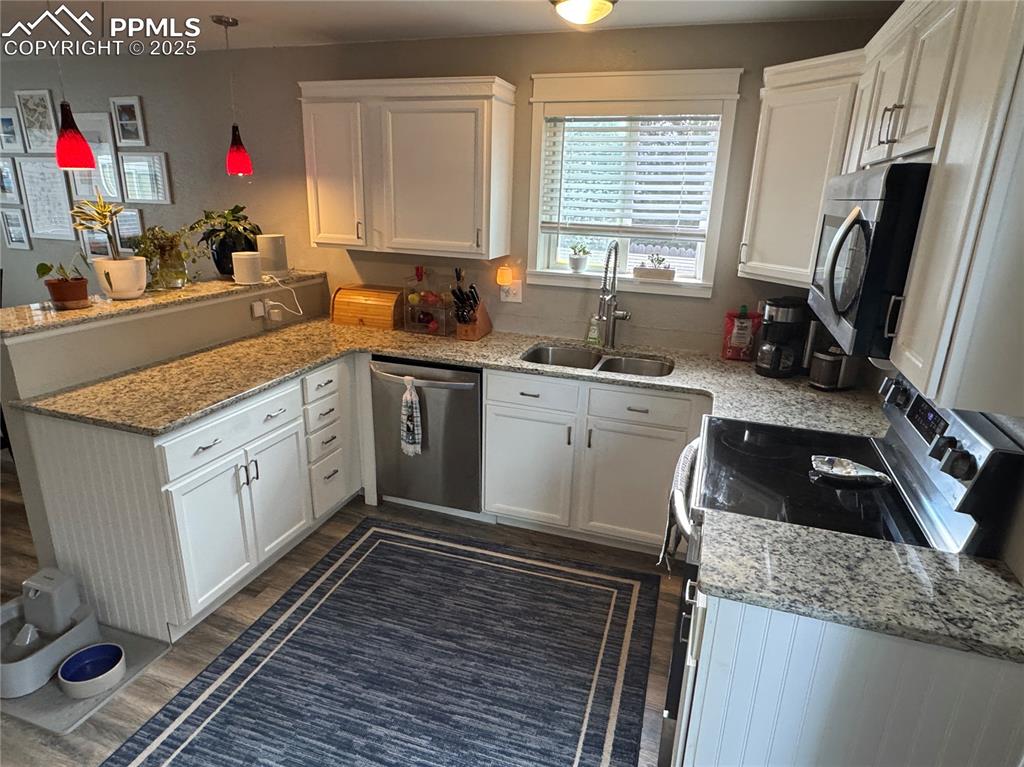 Image 7 of 40: Kitchen with white cabinets